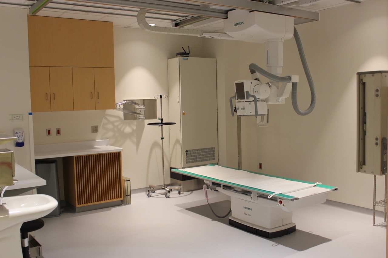 An empty radiography room with medical equipment